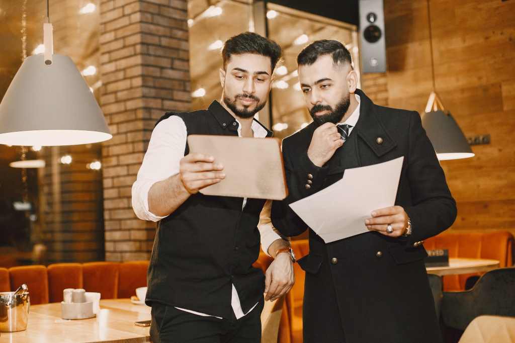 Two man preparing a menu for a restaurant